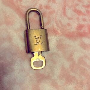 Authentic Louis Vuitton lock and key number 451. Some scratches gently loved